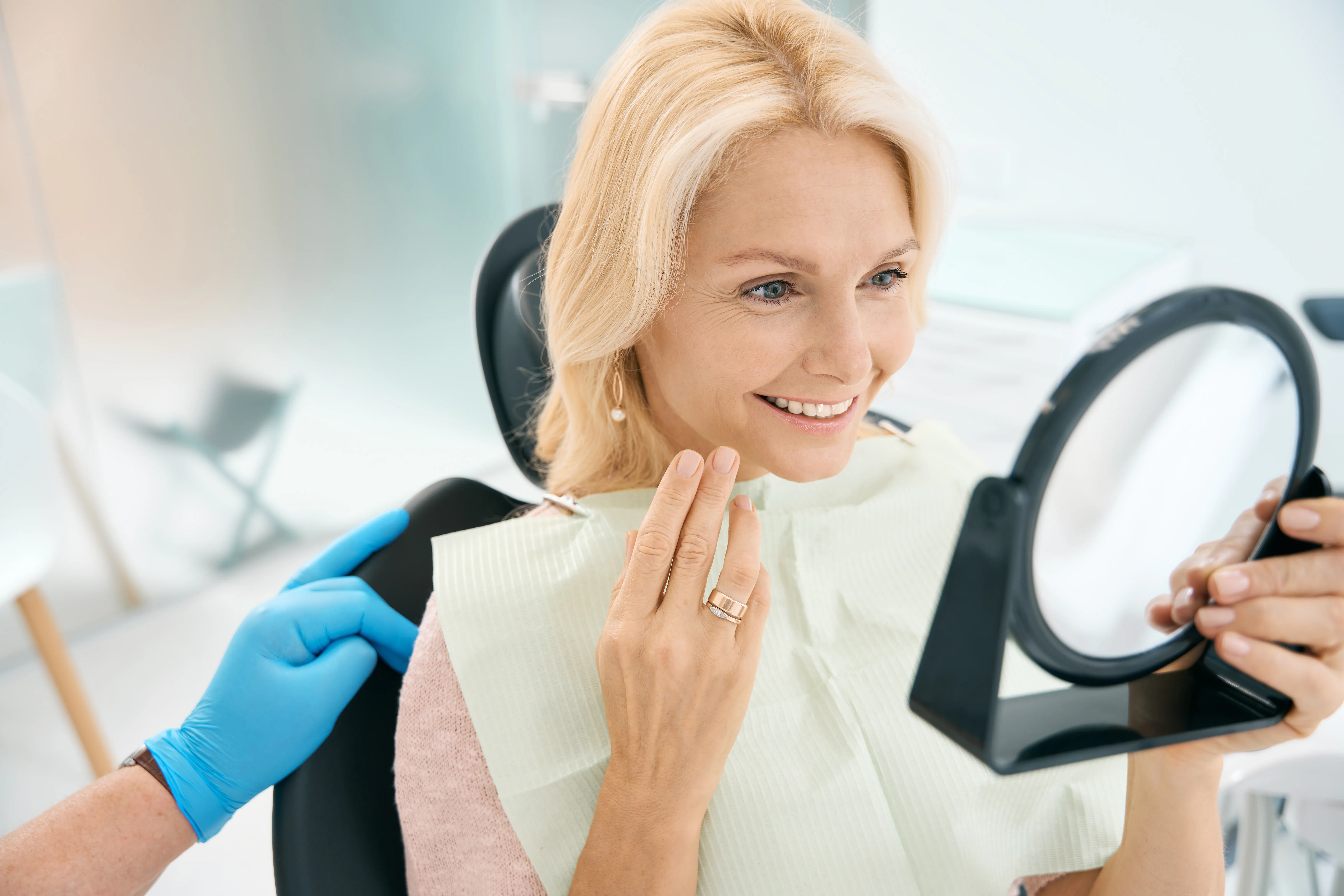 Patient viewing her healthy smile during a general dentistry visit